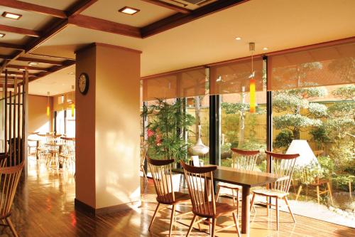 a dining room with a table and chairs at Izumo Royal Hotel in Izumo