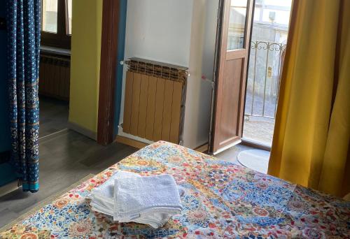 a bed in a room with a towel on it at Pinerolo medievale in Pinerolo