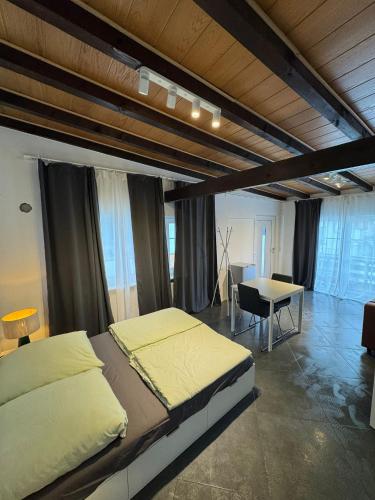 a bedroom with a large bed and a table at F3 - 1 Zimmer Wohnung in Offenbach