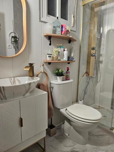 a bathroom with a toilet and a sink and a shower at La Manga Beach House in La Manga del Mar Menor