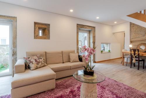 a living room with a couch and a table at Rustic & Modern Stone House by Host Wise in Pedroso
