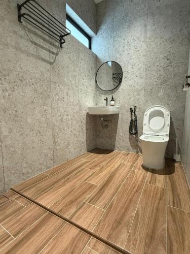 a bathroom with a toilet and a sink at Taiping Corner Homestay in Taiping