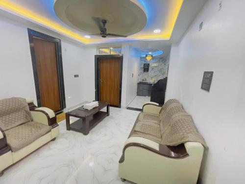 a living room with two couches and a table at Radhika 1 BHK Home Stay Apartment in Vrindāvan