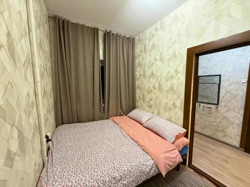 a small bedroom with a bed and a window at Romantic place in Darkhon