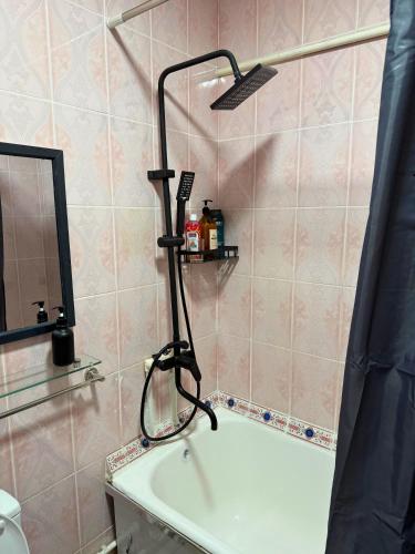 a shower head sitting on top of a bath tub at Romantic place in Darkhon