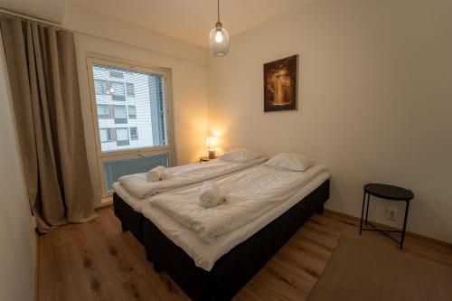 a bedroom with a bed with two stuffed animals on it at Snowflake XII Family rooms in Rovaniemi