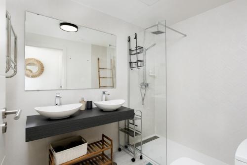 a bathroom with two sinks and a shower at Golden View 2460 in Manilva