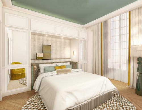 a bedroom with a large white bed and windows at Hôtel Almarine Eiffel by Malone in Paris