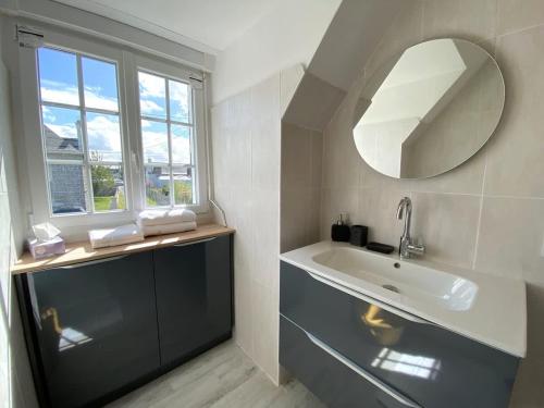 a bathroom with a sink and a mirror at TY AR POKOU Carantec in Carantec