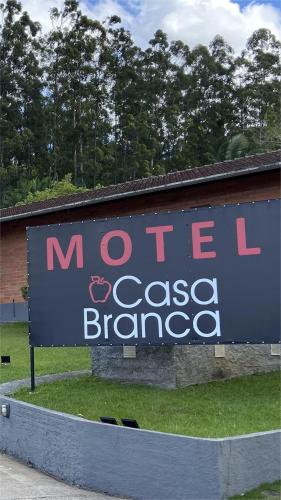 a sign for a store in front of a building at Motel Casa Branca in Blumenau
