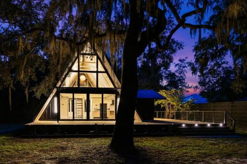 a house with a tree in front of it at A-Frame Villas & Lodges LLC in Kitengela 