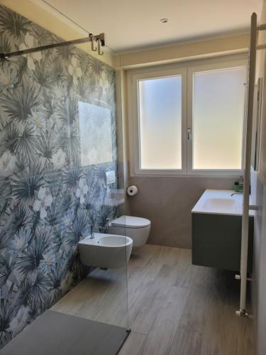 a bathroom with two sinks and a toilet at Casa Paolina in Premeno