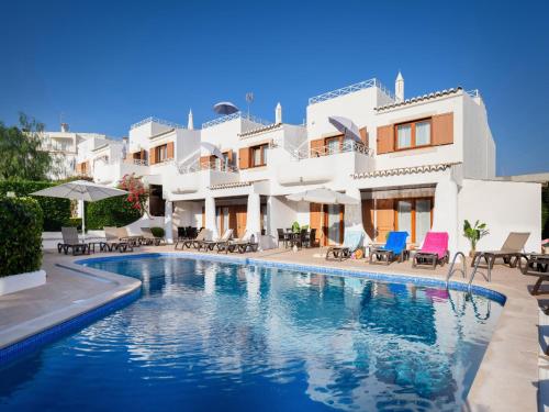a swimming pool in front of a villa at Akisol Olhos de Água Ocean in Albufeira