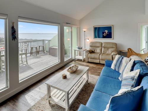 a living room with a blue couch and a table at Sunset Water View in Padre Island