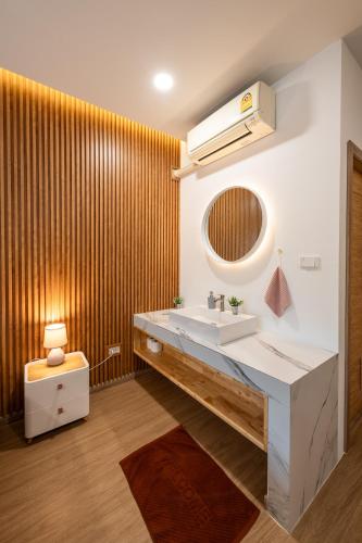 a bathroom with a sink and a mirror at VivaDeva , Pool Villa In Nimman 4BR Near MAYA MALL in Chiang Mai