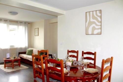 a dining room with a table and four chairs at Issam in Lyon