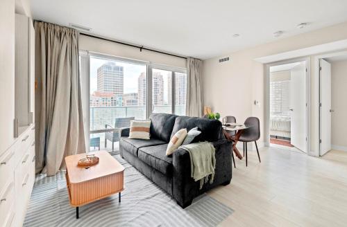 a living room with a couch and a large window at Panoramic 2 Bedroom plus Den Condo Yonge Street Downtown Toronto in Toronto