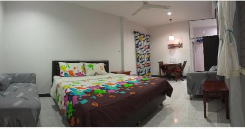 a bedroom with a large bed and a living room at Bangtoa room with kitchen near Lotus MMA & Beach in Bang Tao Beach