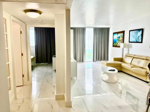 a living room with a couch and a table at Ocean Reserve Luxury Condo Sunny Isles Beach in Sunny Isles Beach
