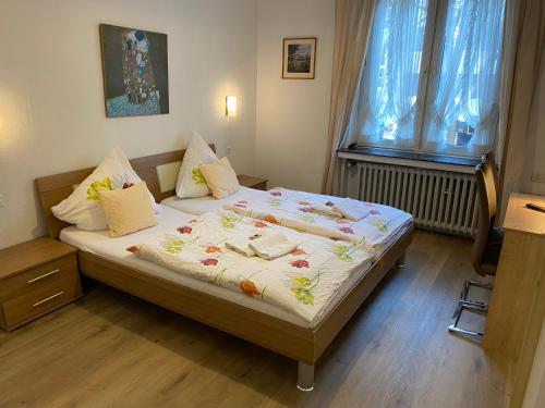 a bedroom with a large bed with towels on it at Hotel Haus Schwan Köln in Cologne