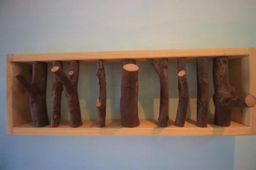 a wooden shelf with a bunch of weapons on it at Yun Tien Feng Chuan B&B in Dongshan