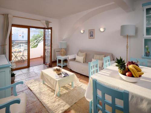 a living room with a table and chairs and a couch at Akisol Olhos de Água Ocean in Albufeira