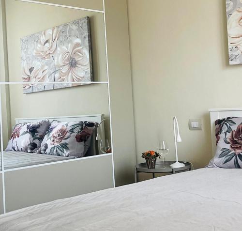 a bedroom with a mirror next to a bed at B33 A natural tilt for beauty in Pisa