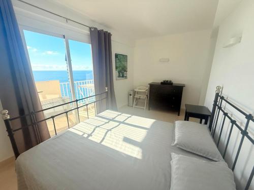 Postel nebo postele na pokoji v ubytování La Perla vista al mar