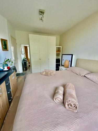a bedroom with two rolled towels on a bed at Spacious Room with private king bathroom in Amsterdam