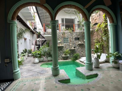 a courtyard with a swimming pool in a building at Casa Verde Hotel in Santa Marta