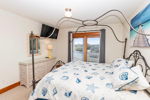 a bedroom with a bed and a window at SEMI-OCEANFRONT, Wild Horses, Private Pool-4x2238, Finally Here in Knotts Island