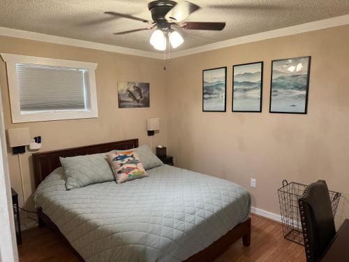 a bedroom with a bed with a ceiling fan at The Fishing Hole #4 Near Town in Bryson City