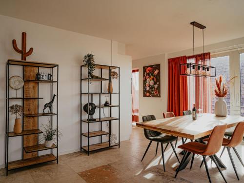 a dining room with a table and chairs at Apartment De Zeeparel by Interhome in Egmond aan Zee