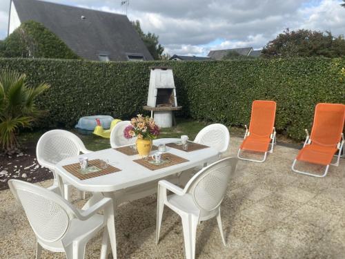 a white table and chairs in a yard at Holiday Home Côte des îles by Interhome in Portbail
