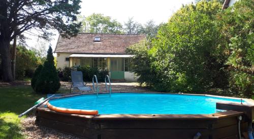 a swimming pool in the backyard of a house at La Petite Pommerie in Chaumont-sur-Loire