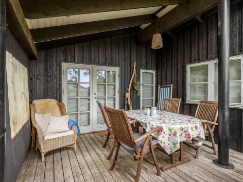 a patio with a table and chairs on a deck at Holiday Home Danko - 1-5km from the sea by Interhome in Fanø