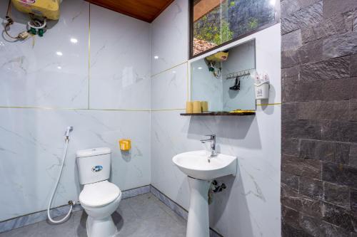 a bathroom with a toilet and a sink at Chezbeo Bungalow Ninh Binh in Vũ Lâm