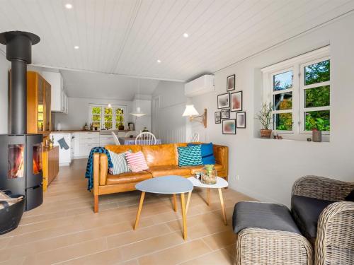 a living room with a couch and a table at Holiday Home Teijo - 2-5km from the sea by Interhome in Ebeltoft