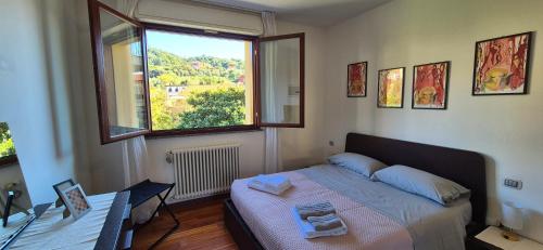 Un dormitorio pequeño con una cama y una ventana. en Casa Bi', en La Spezia