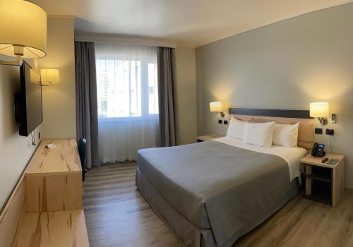 a hotel room with a large bed and a window at Diego de Almagro Providencia Express in Santiago