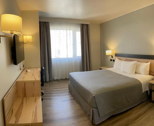 a hotel room with a bed and a window at Diego de Almagro Providencia Express in Santiago