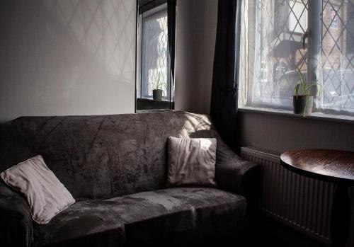 a couch in a living room with a window at Oliver Twist Country Inn in Wisbech
