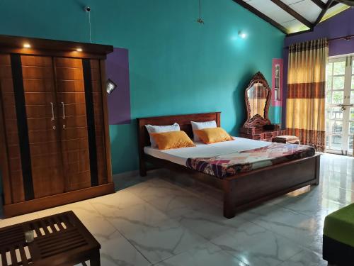 a bedroom with a bed and a blue wall at Ceylon Traveller Homestay in Panadura