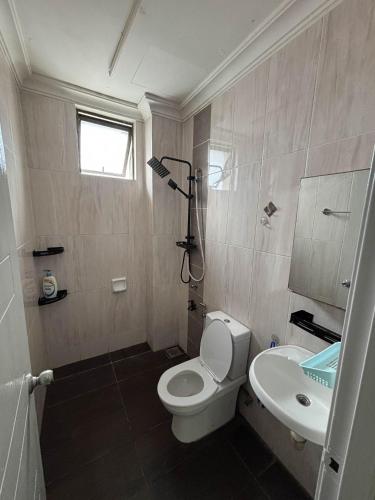 a bathroom with a white toilet and a sink at SBFAM HOMESTAY SHAH ALAM SEKSYEN 7 - NEAR i-CITY AND UITM in Shah Alam