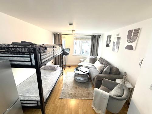 a living room with a bunk bed and a couch at 15 min walk to Tower Bridge in London