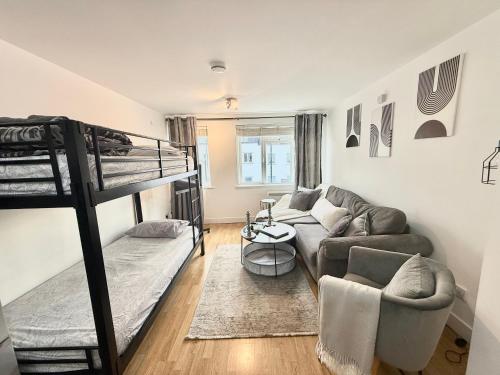 a living room with two bunk beds and a couch at 15 min walk to Tower Bridge in London