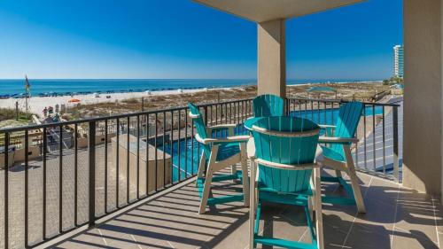 a balcony with two chairs and the beach at Phoenix X 211 condo in Orange Beach