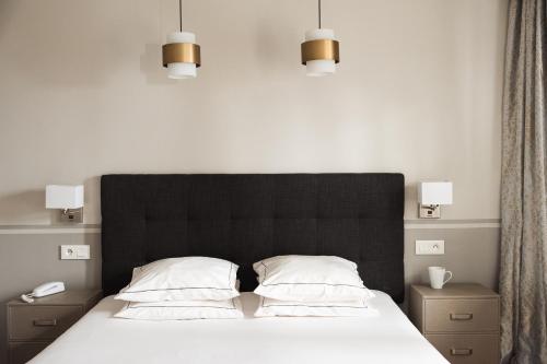 Postel nebo postele na pokoji v ubytování Hôtel Eiffel Segur