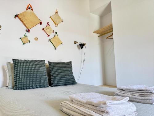 a bedroom with a bed with towels on it at Casa da Capela - CASAS BEMHAJA in São Miguel de Acha