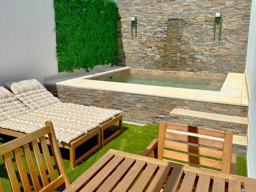 a patio with two chairs and a swimming pool at Casa da Laje - Casas BemHaja in São Miguel de Acha